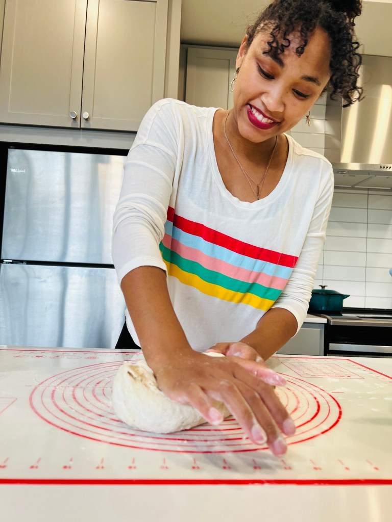 Blair Baker kneads dough on a baking mat on a kitchen counter